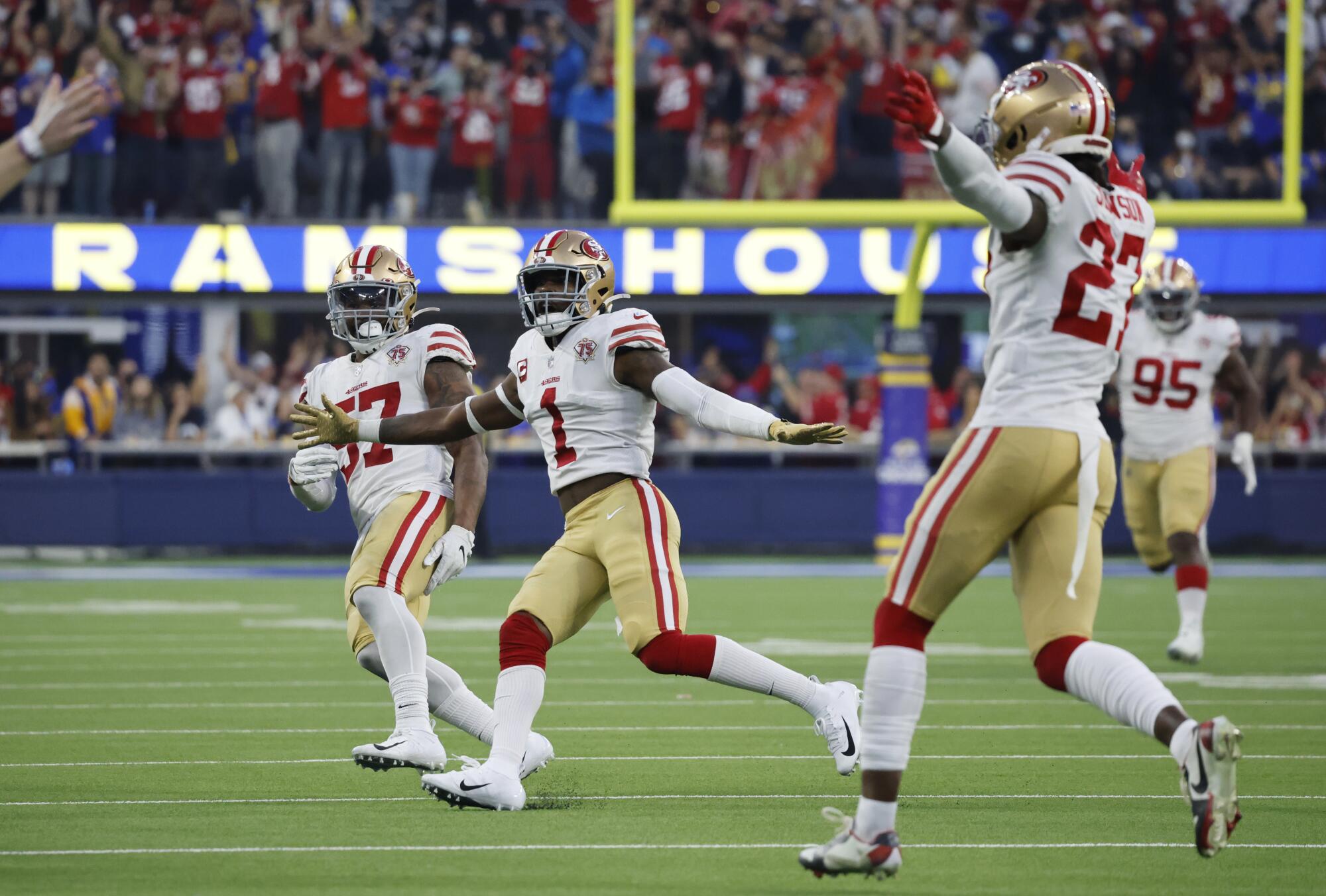 San Francisco's Dre Greenlaw, Jimmie Ward and Dontae Johnson react after an interception by teammate Ambry Thomas.