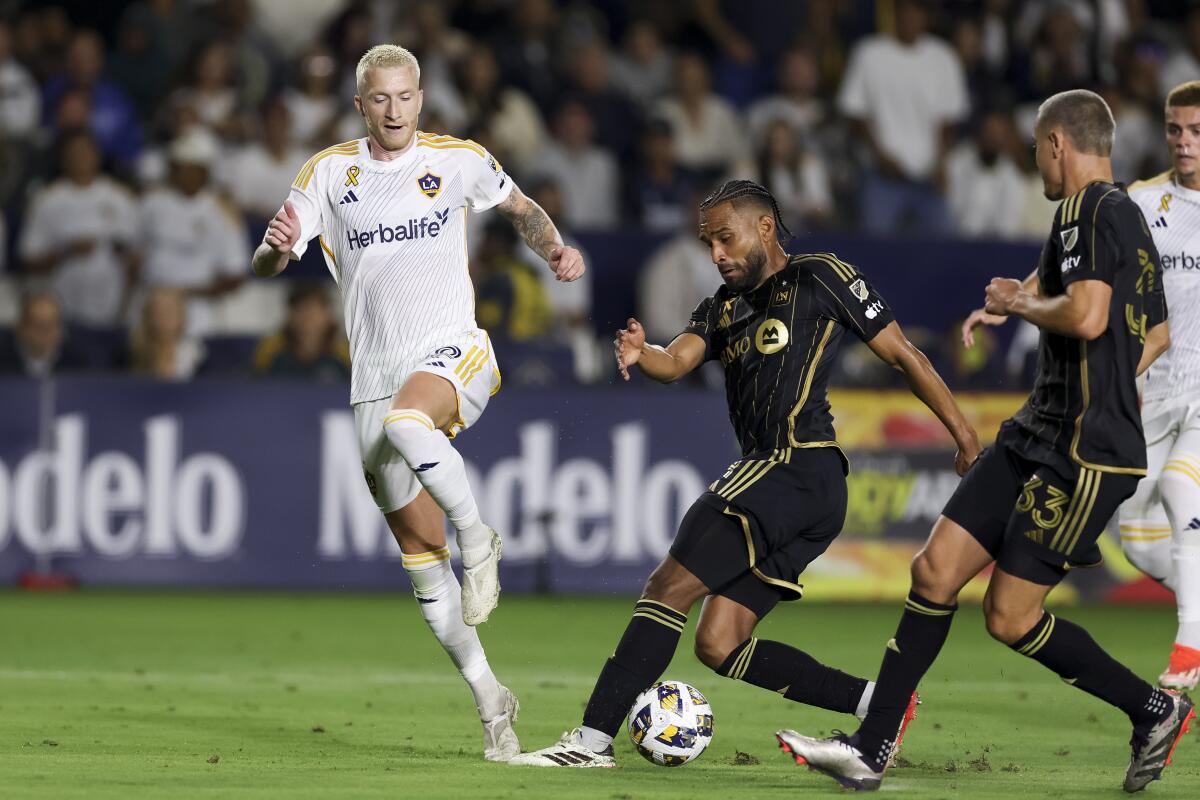 Los Angeles Galaxy forward Marco Reus, left, vies for the ball against