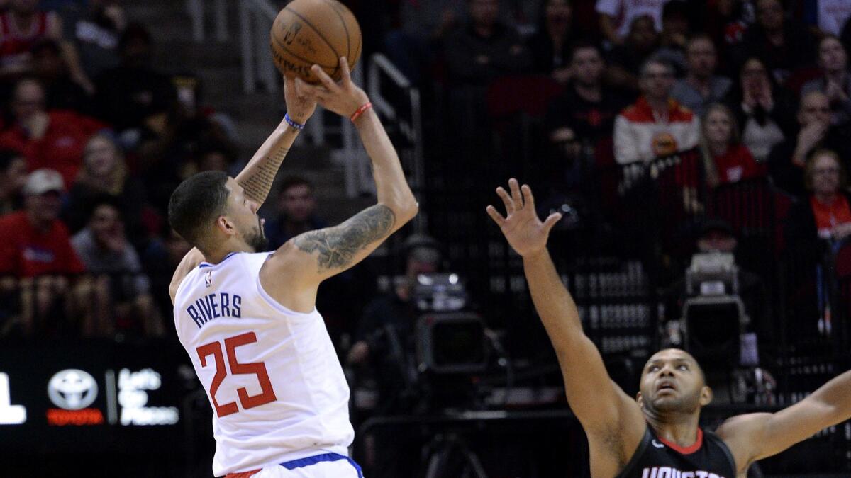 Clippers guard Austin Rivers shoots a three-pointer over Rockets guard Eric Gordon during the second half Friday night.