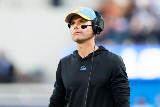 Chargers coach Brandon Staley watches from the sideline during a game against the Broncos.