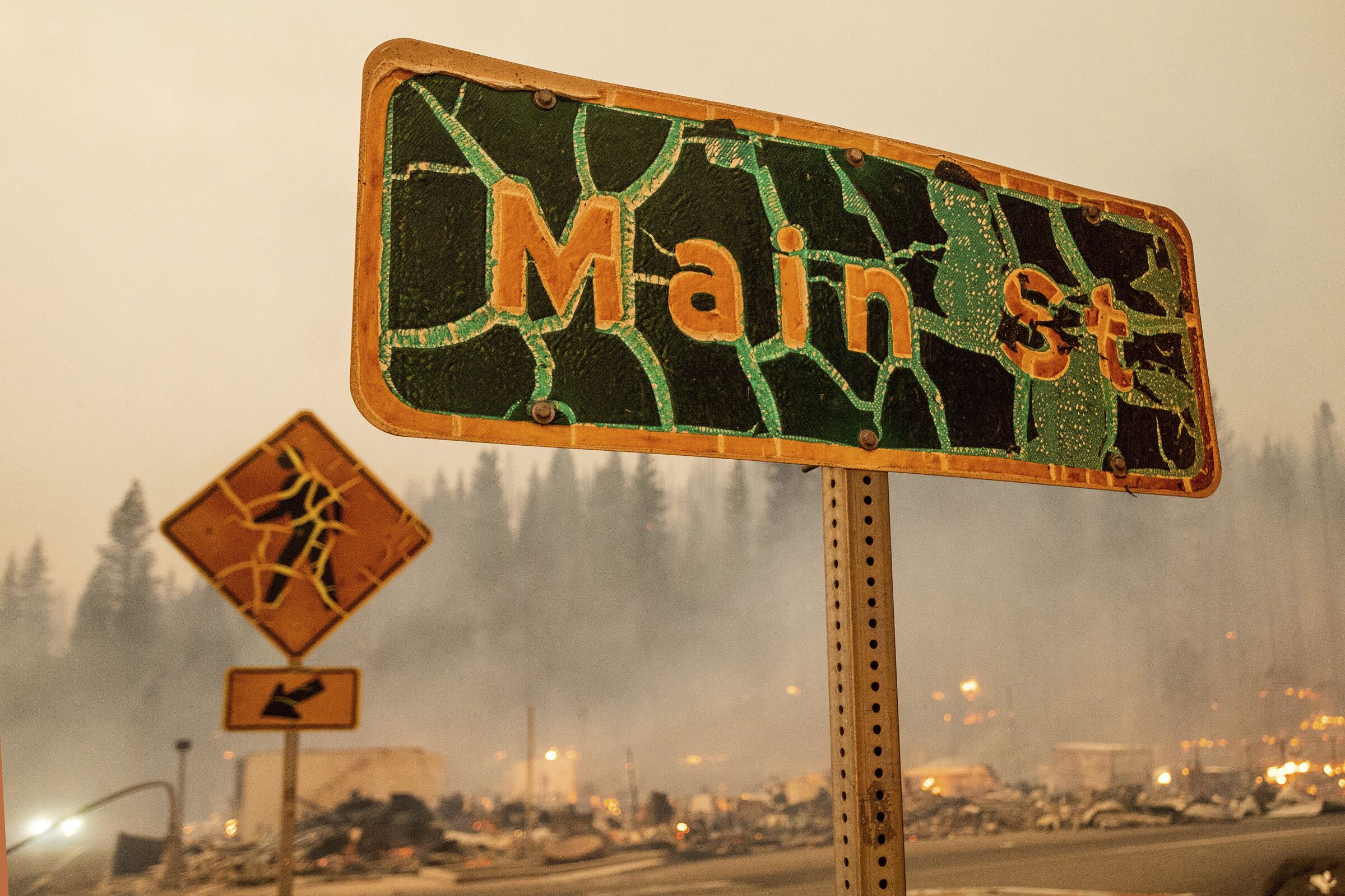 A damaged sign reading "Main St" stands in central Greenville
