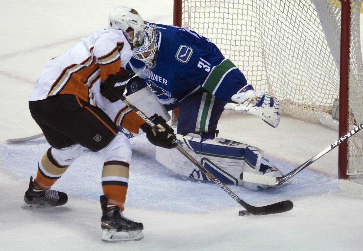 Defenseman Cam Fowler tries to shoot past Canucks goalie Eddie Lack during the first period of a game Monday in Vancouver. The Ducks lost to the Canucks, 2-1.