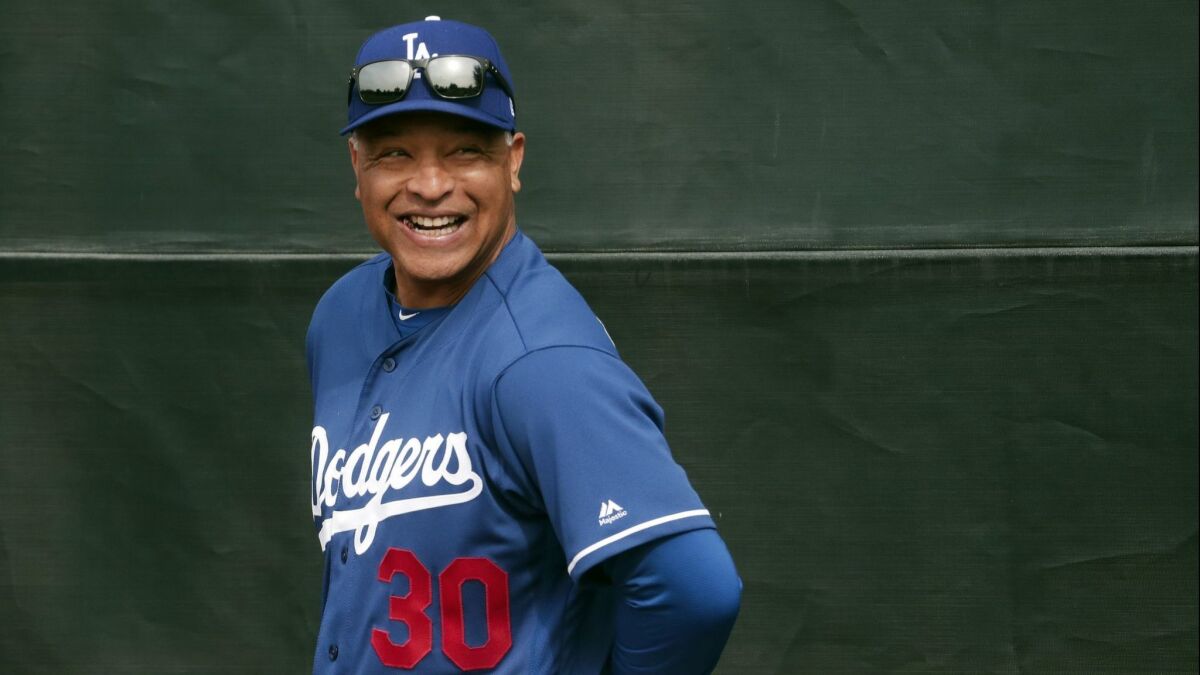 Dodgers manager Dave Roberts smiles during a spring training workout Feb. 13. Will Roberts be able to guide the Dodgers to a third straight World Series?