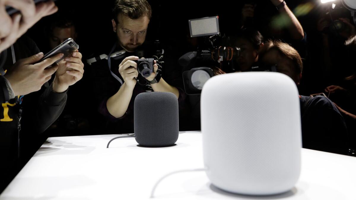 Photographers take pictures of Apple's HomePod speaker in June, when the product was announced.