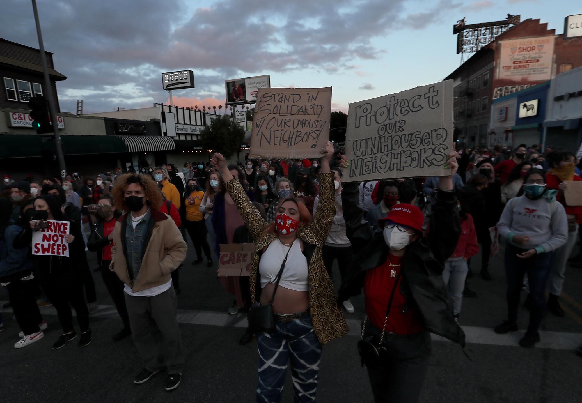 People march down Sunset Boulevard to protest the closure of a homeless camp in Echo Park.