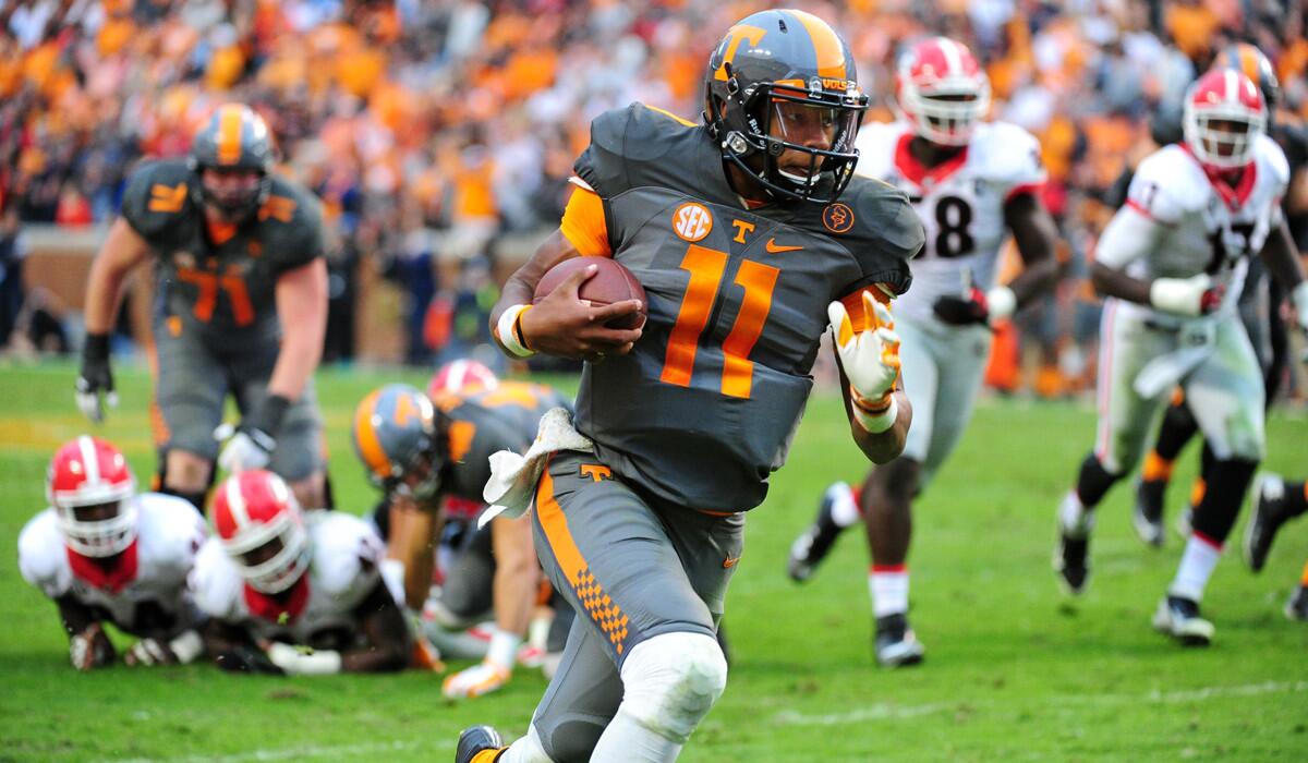 Tennessee's Joshua Dobbs carries the ball against the Georgia Bulldogs on Saturday.