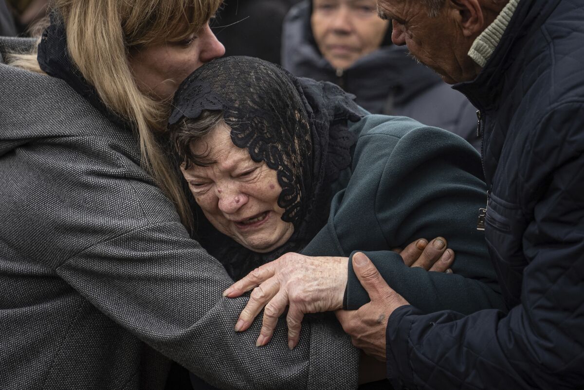 Mother of slain Ukrainian serviceman crying at his funeral