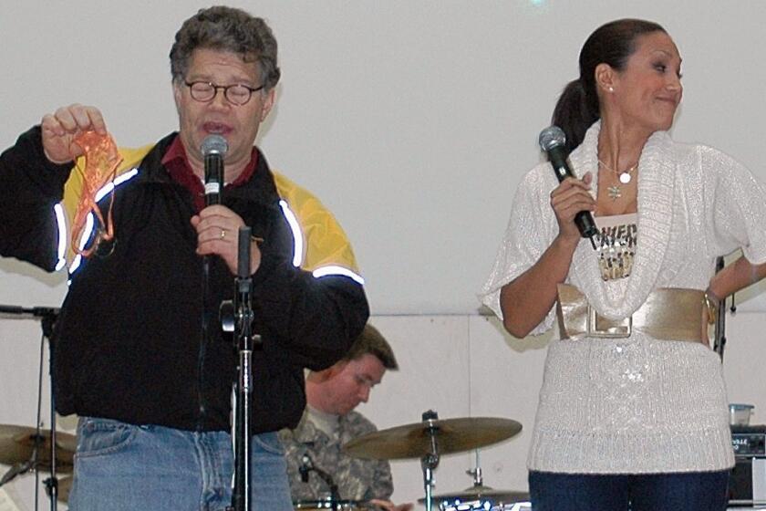 In this image provided by the U..S,. Army, then-comedian Al Franken and sports commentator Leeann Tweeden perform a comic skit at Forward Operating Base Marez in Mosul, Iraq, on Dec. 16, 2006, during the USO Sergeant Major of the Army's 2006 Hope and Freedom Tour. Sen. Al Franken, D-Minn., apologized Nov. 16, 2017, after Tweeden accused him of forcibly kissing her during the 2006 USO tour. Colleagues, including fellow Democrats, urged a Senate ethics investigation. Tweeden also accused Franken of posing for a photo with his hands on her breasts as she slept, while both were performing for military personnel two years before the one-time comedian was elected to the Senate. (Creighton Holub/U.S. Army via AP)