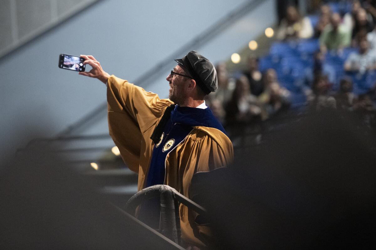 Engineering dean Magnus Egerstedt takes a selfie with the graduates.