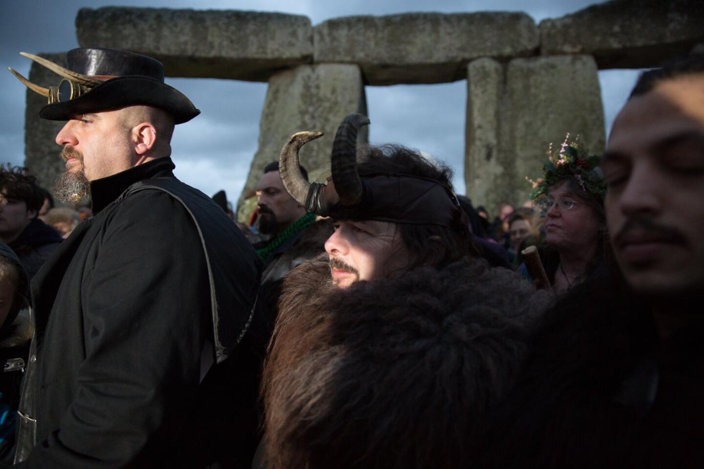 Druids, pagans and revellers gather at Stonehenge, hoping to see the sun rise, as they take part in a winter solstice ceremony Dec. 22, 2015, in Wiltshire, England.