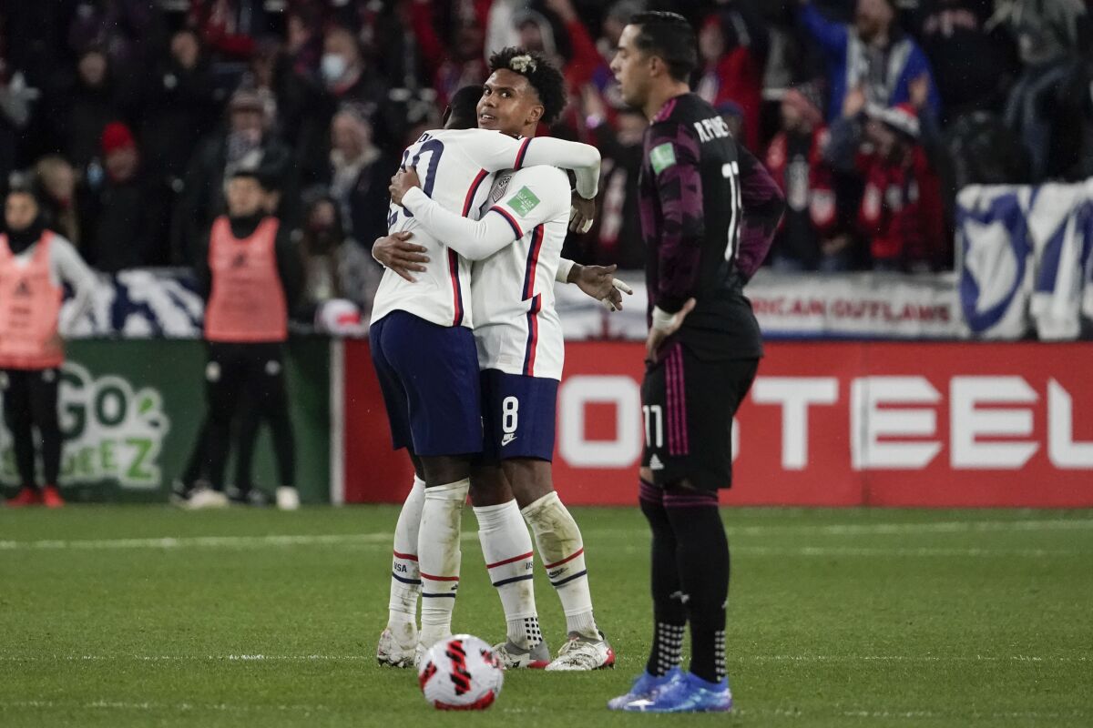 U.S. midfielder Weston McKennie, center, celebrates with teammate Tim Weah after scoring