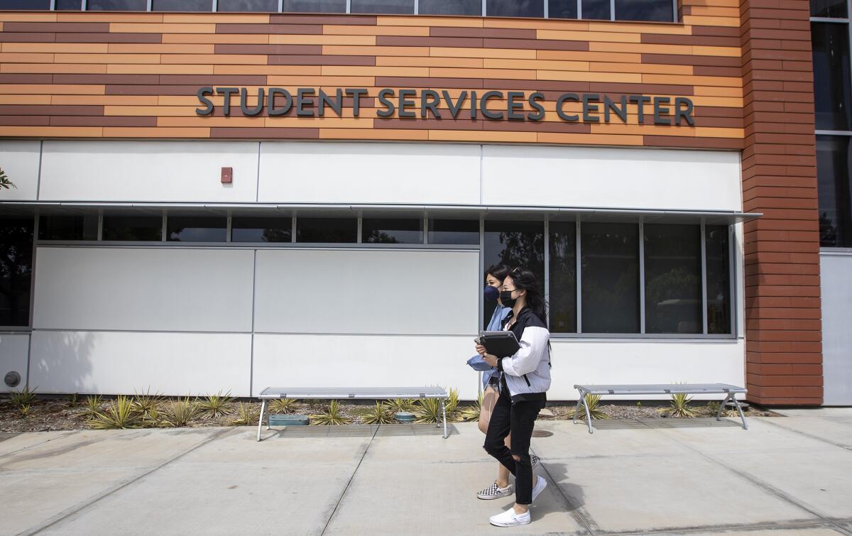 Students walk past the Student Services Center at Golden West College.