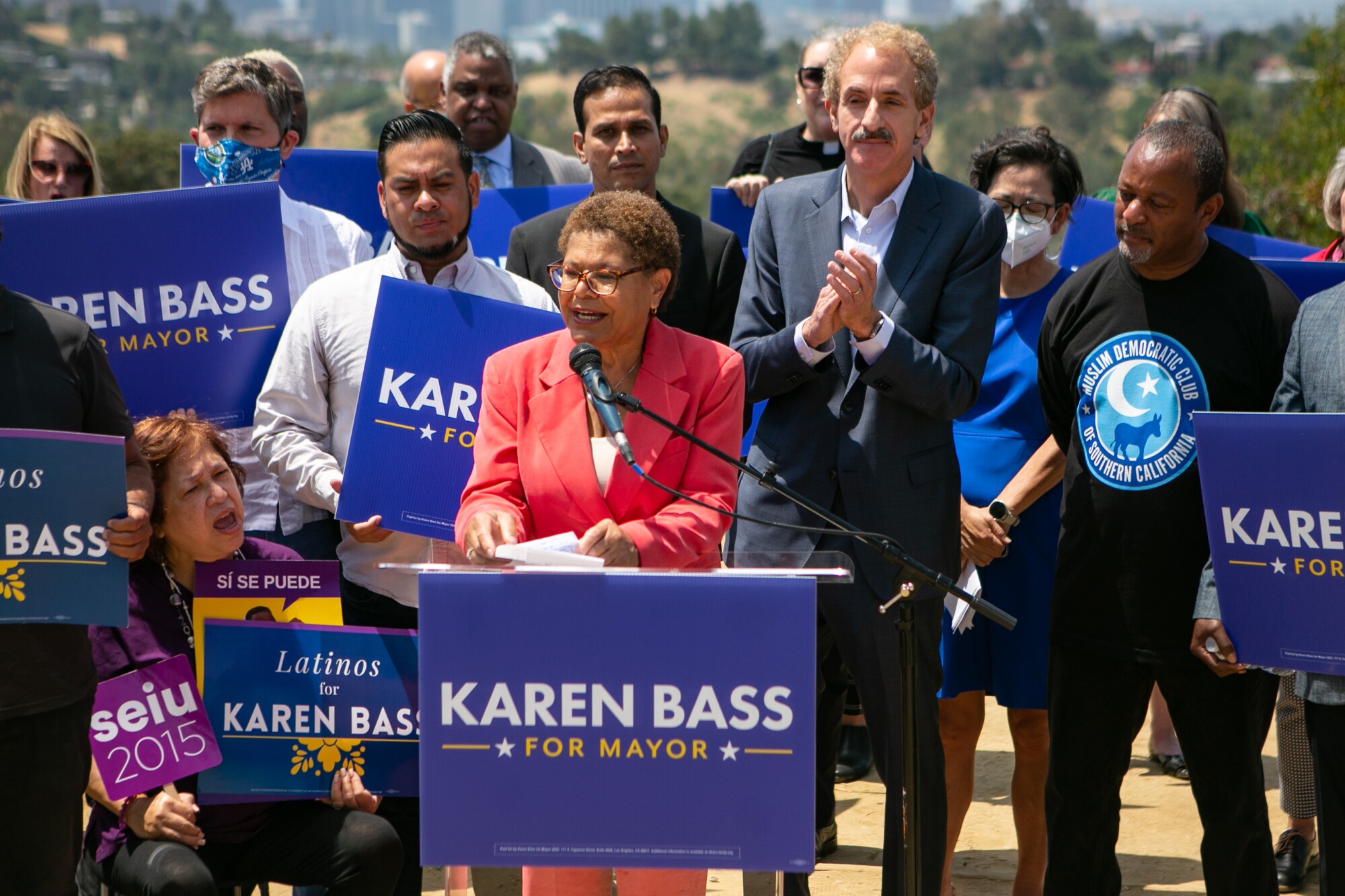 Karen Bass speaks as supporters hold "Karen Bass for Mayor" signs.