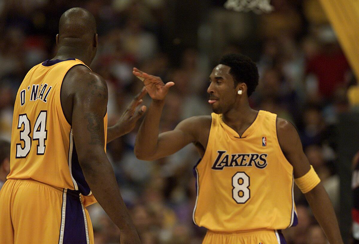 Kobe Bryant and Shaquille O'Neal celebrate a Lakers win.