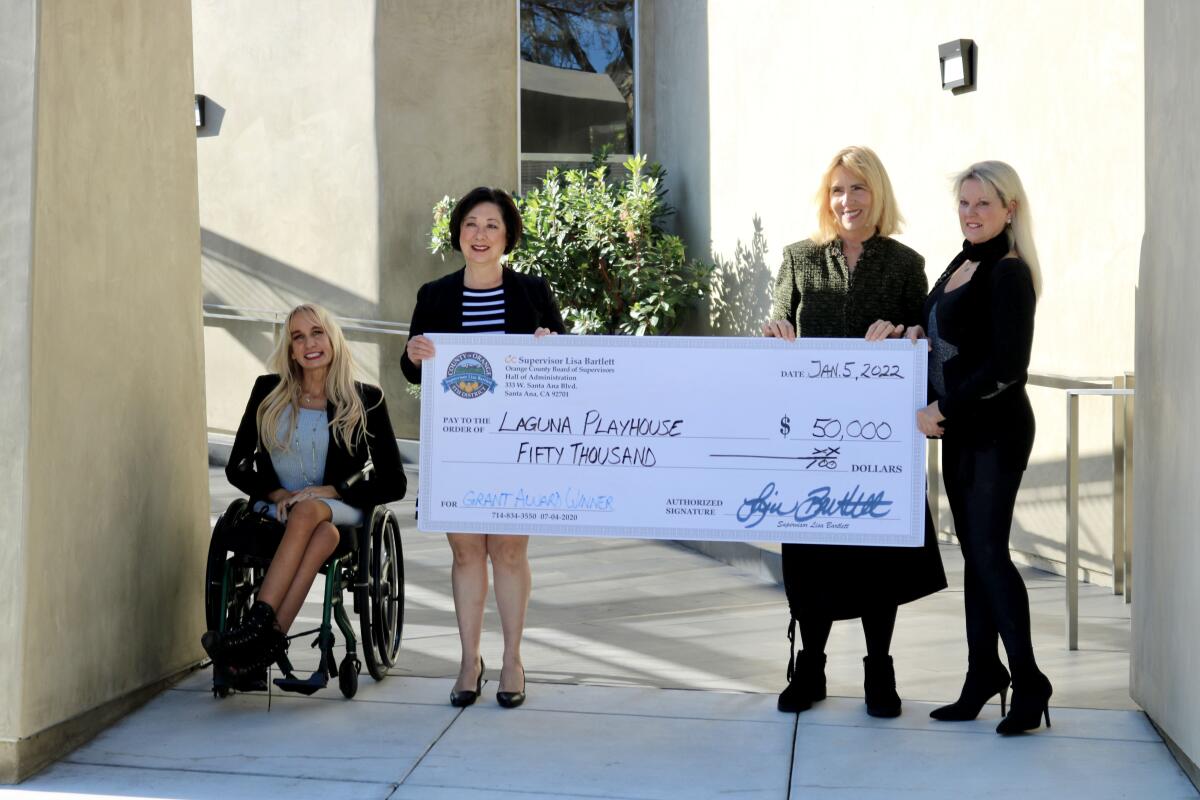 Erin O'Flaherty,  Lisa Bartlett, Executive Director Ellen Richard and board member Heidi Miller with a $50,000 grant check.