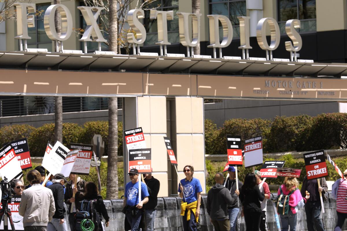 WGA members walk the picket line on the second day of their strike in front of Fox Studios. 