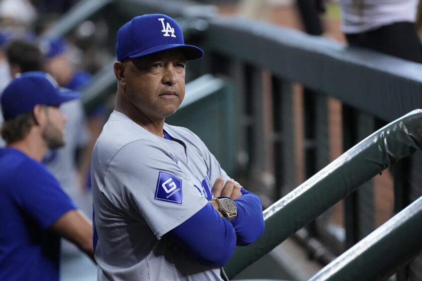 Los Angeles Dodgers manager Dave Roberts stands in the dugout before a baseball game against the Houston Astros, Saturday, July 27, 2024, in Houston. (AP Photo/Kevin M. Cox)