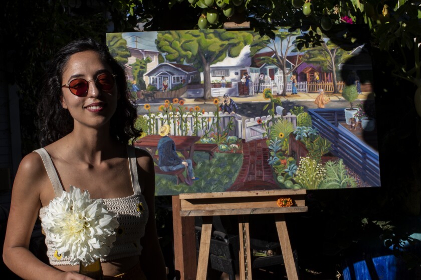 Vaziri stands in front of her oil painting titled "Navy Street" after the garden she created at her old home in Santa Monica.