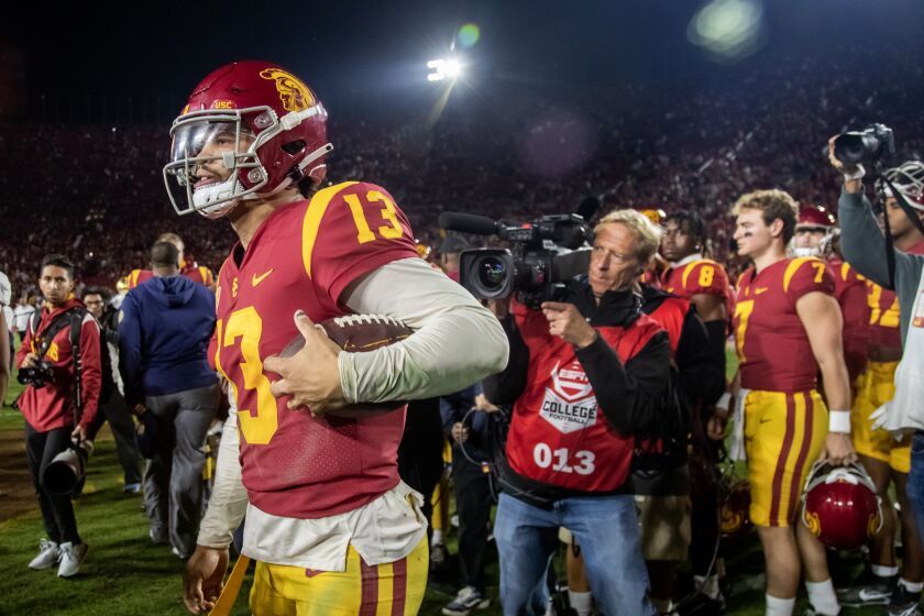 USC quarterback Caleb Williams carries the game ball as he leaves the field after a win over Notre Dame on Nov. 26, 2022.