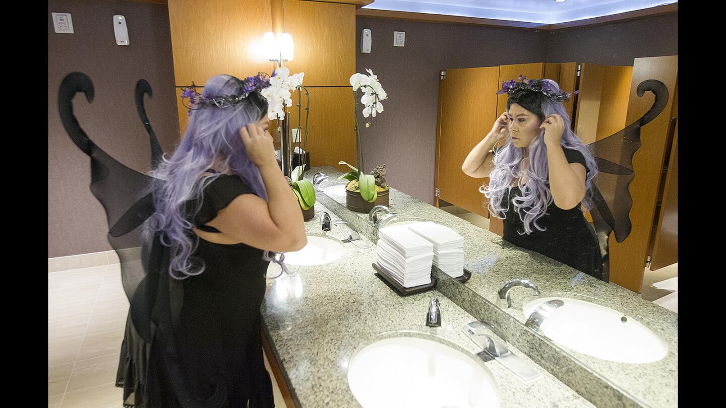 Monique Frankfort, director of group sales at the Westin South Coast Plaza hotel in Costa Mesa, adjusts a wig on her dark-fairy costume. Five members of the sales team dressed up to meet with local clients Monday to thank them and drop off Halloween cookies.