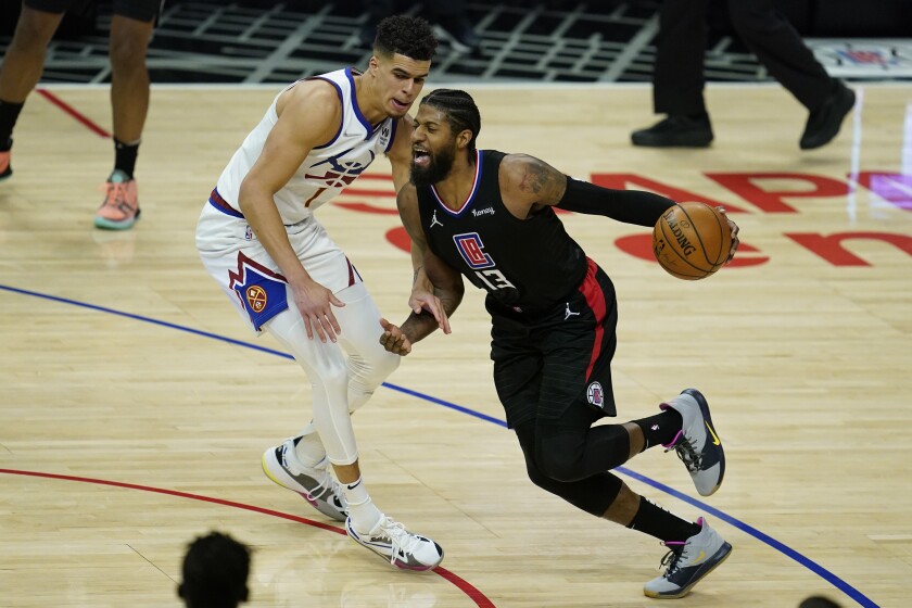 Denver Nuggets forward Michael Porter Jr. (1) defends against LA Clippers guard Paul George (13) during the second quarter of an NBA basketball game Thursday, April 1, 2021, in Los Angeles. (AP Photo/Ashley Landis)