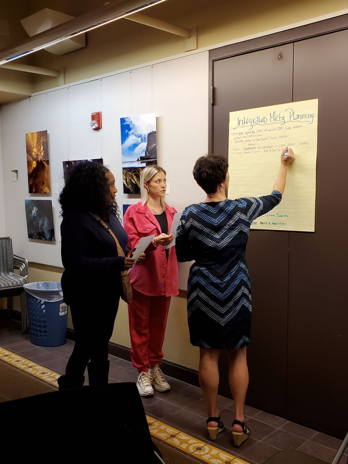 Artillia Marcellous, Lauren Turton and Karen Roque brainstorm ideas to improve integrated marketing planning.