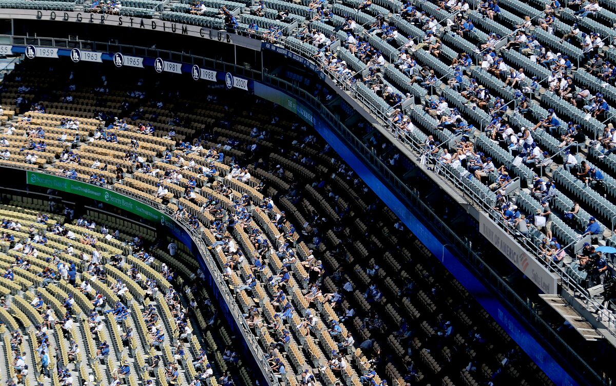 Socially distanced fans attend the Dodgers' home opener Friday, April 9, 2021.