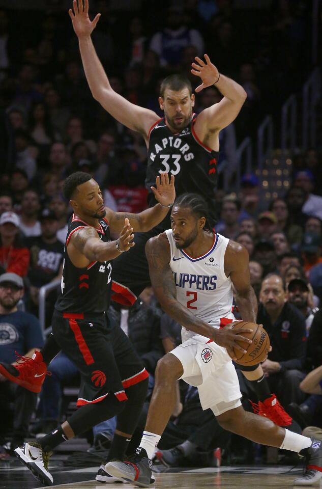 Clippers forward Kawhi Leonard tries to work through the Raptors defense during the fourth quarter of a game Nov. 11 at Staples Center.