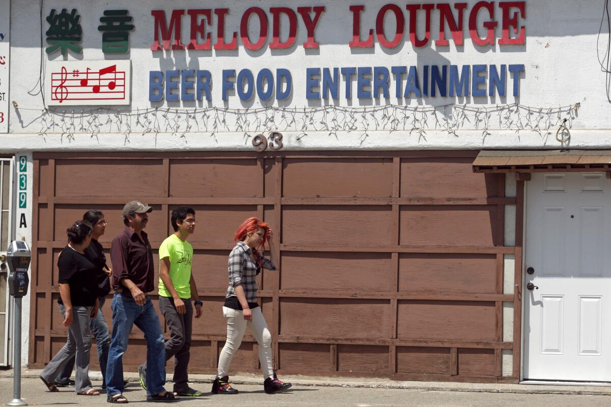 LOS ANGELES, CA August 6, 2013 -- Pedestrians walk by Melody Lounge in Los Angeles on Thursday, August 7, 2013. A new wave of restaurants and bars will bring a new taste and culture into Chinatown district. (Cheryl A. Guerrero / Los Angeles Times)