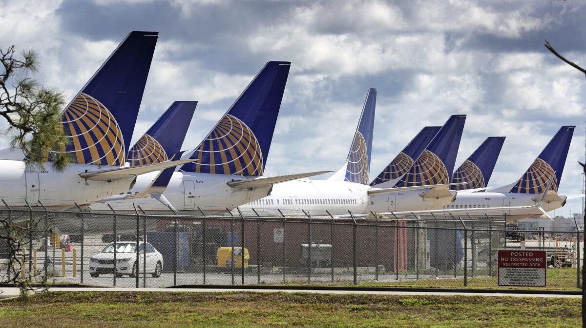 FILE - United Airlines planes are parked at Orlando International Airport, in a Tuesday, April 7, 2020 file photo, in Orlando, Fla. United Airlines said Tuesday, July 21 that it lost $1.63 billion in the second quarter as revenue plunged 87%, and it will operate at barely over one-third of capacity through September as the coronavirus throttles air travel. (Joe Burbank/Orlando Sentinel via AP, File)
