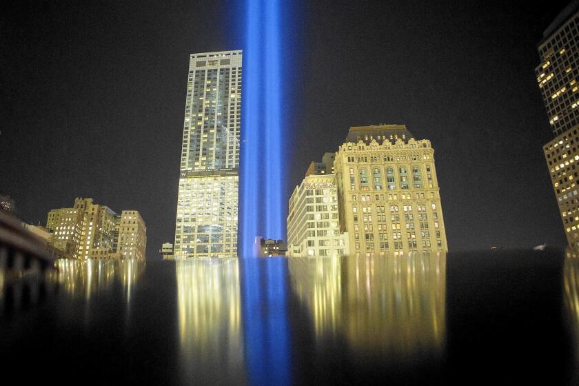 Tribute in Light is reflected on the 9/11 Memorial in New York. As the U.S. increases its military presence in the Middle East, Americans express ambivalence.