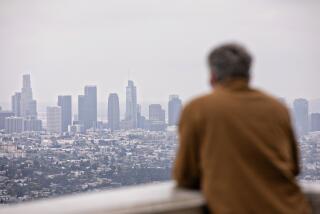 Los Angeles, CA - May 09: A man enjoys an overcast day at the Griffith Observatory on Tuesday, May 9, 2023 in Los Angeles, CA. (Jason Armond / Los Angeles Times)