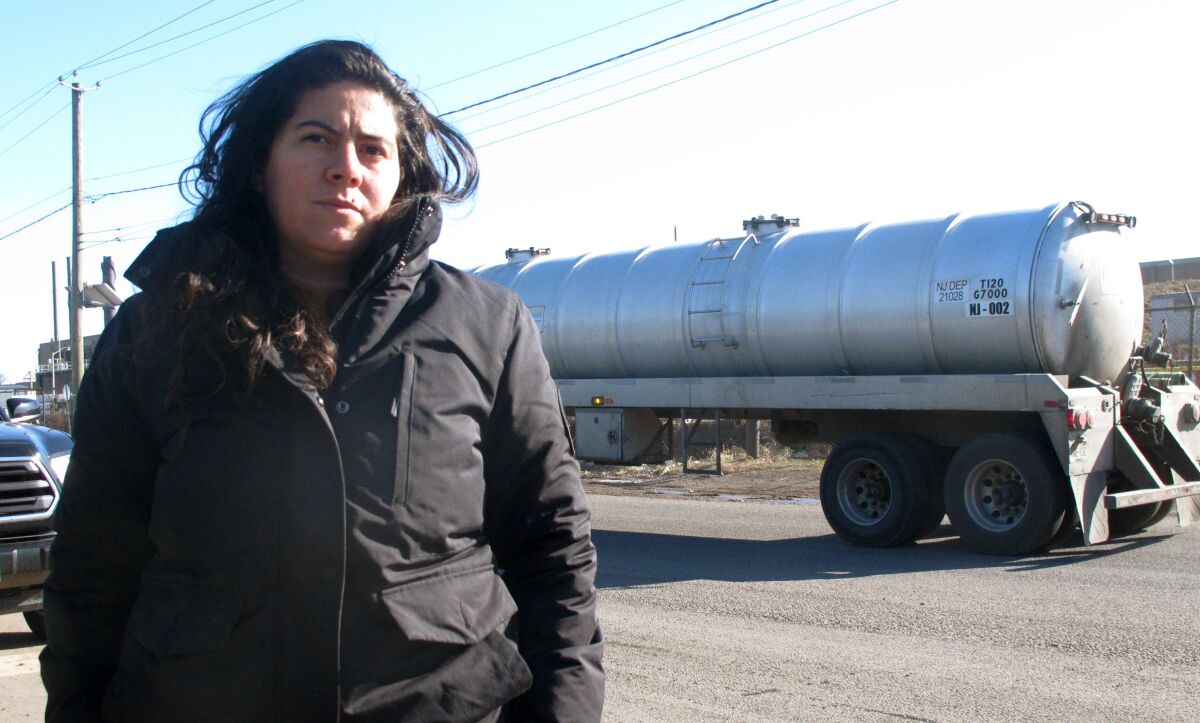 Maria Lopez-Nunez, deputy director of the Ironbound Community Corporation, speaks on Wednesday, Jan. 11, 2022 outside a sewage treatment plant in Newark N.J. A proposed backup power plant is drawing strenuous opposition from residents who say their neighborhood is already overburdened with polluting facilities, including two other power plants. (AP Photo/Wayne Parry)