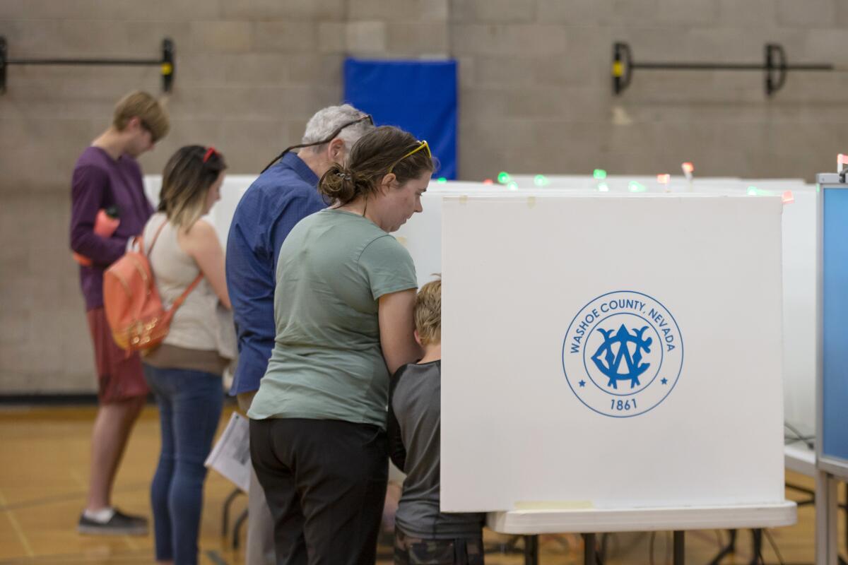 Voters cast ballots at a polling place