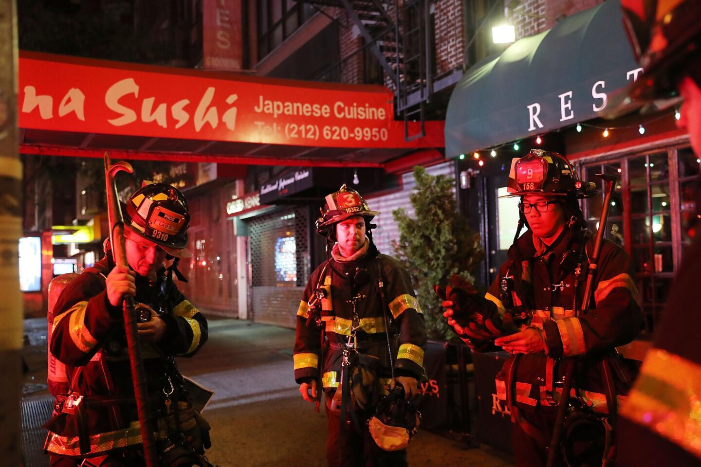 Firefighters gather at the explosion scene in Manhattan's Chelsea neighborhood.
