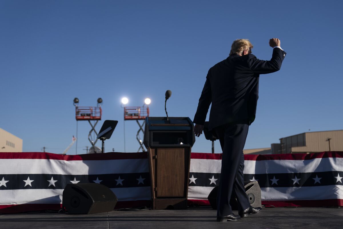 President Trump walks off stage after speaking at a campaign rally in Arizona.