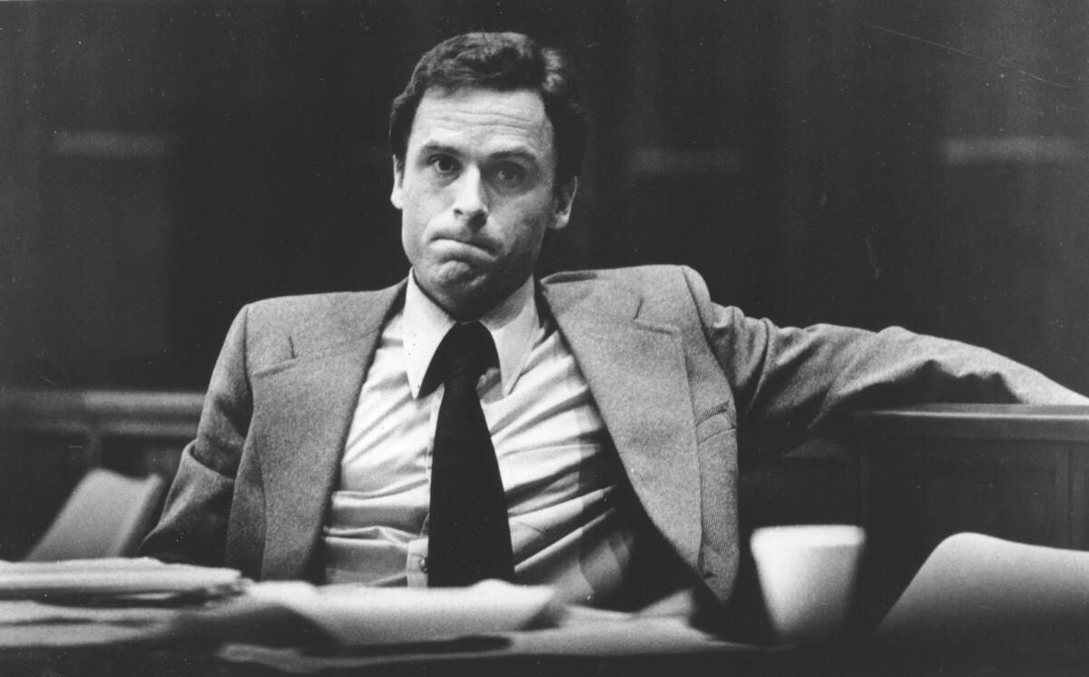 A black-and-white photo of Ted Bundy in a suit