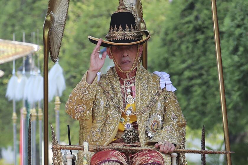 Thailand's King Maha Vajiralongkorn is carried on a palanquin through the streets outside the Grand Palace for the public to pay homage to him on the second day of his coronation ceremony in Bangkok, Sunday, May 5, 2019. Vajiralongkorn was officially crowned Saturday amid the splendor of the country's Grand Palace, taking the central role in an elaborate centuries-old royal ceremony that was last held almost seven decades ago. (AP Photo/Sakchai Lalit)