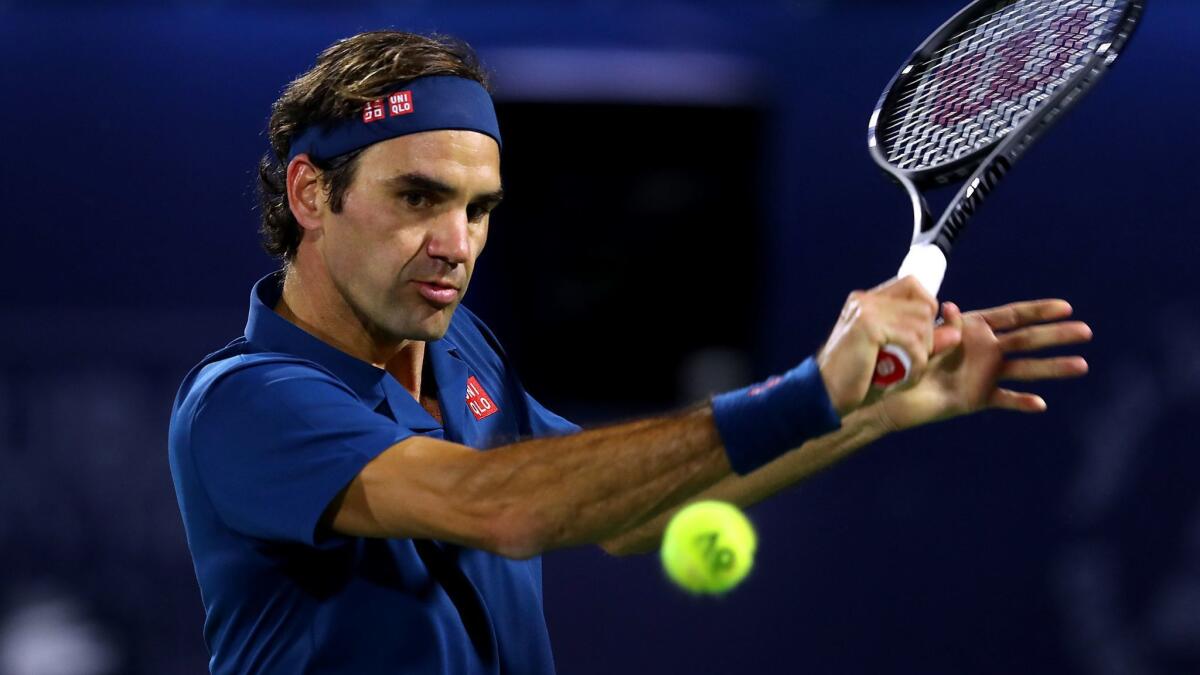 Roger Federer plays a shot in his men's singles final match against Stefanos Tsitsipas at the Dubai Duty Free Championships on Saturday in Dubai, United Arab Emirates.