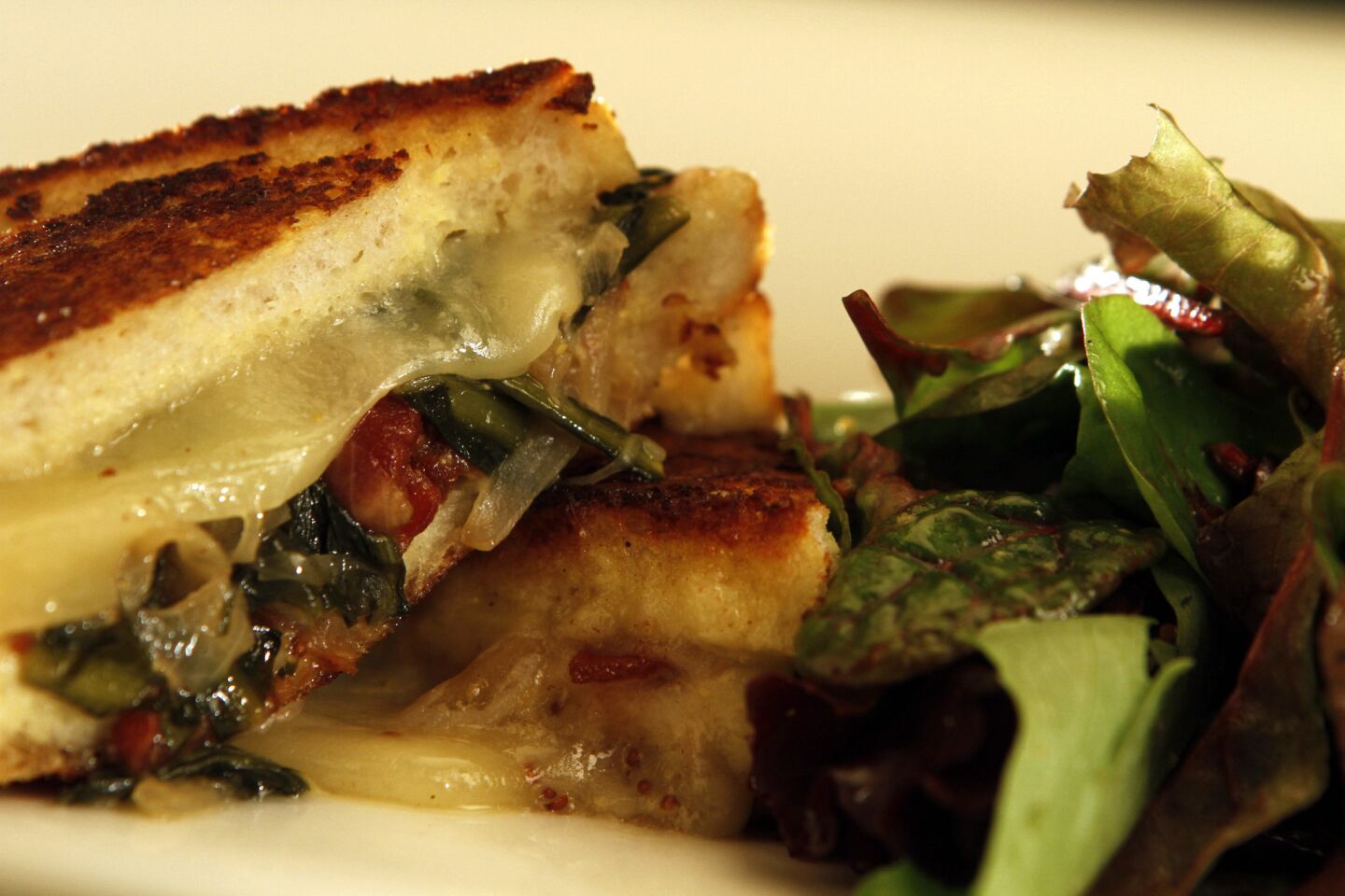 Savory stuffed French toast with bacon, dandelion greens and Gruyere cheese