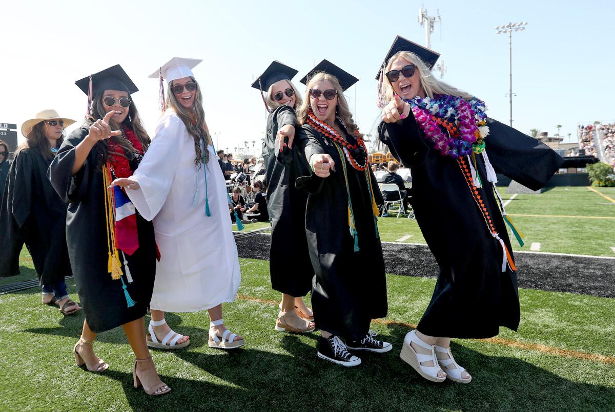 Graduates walk in the processional to the 2022 Huntington Beach High School commencement ceremony on Tuesday.