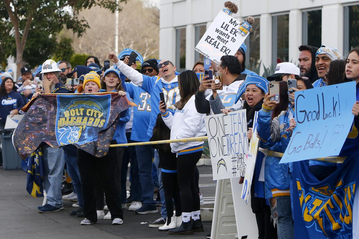 Fans show their support as Los Angeles Chargers players arrive at the Hoag Performance Center in Costa Mesa on Friday.