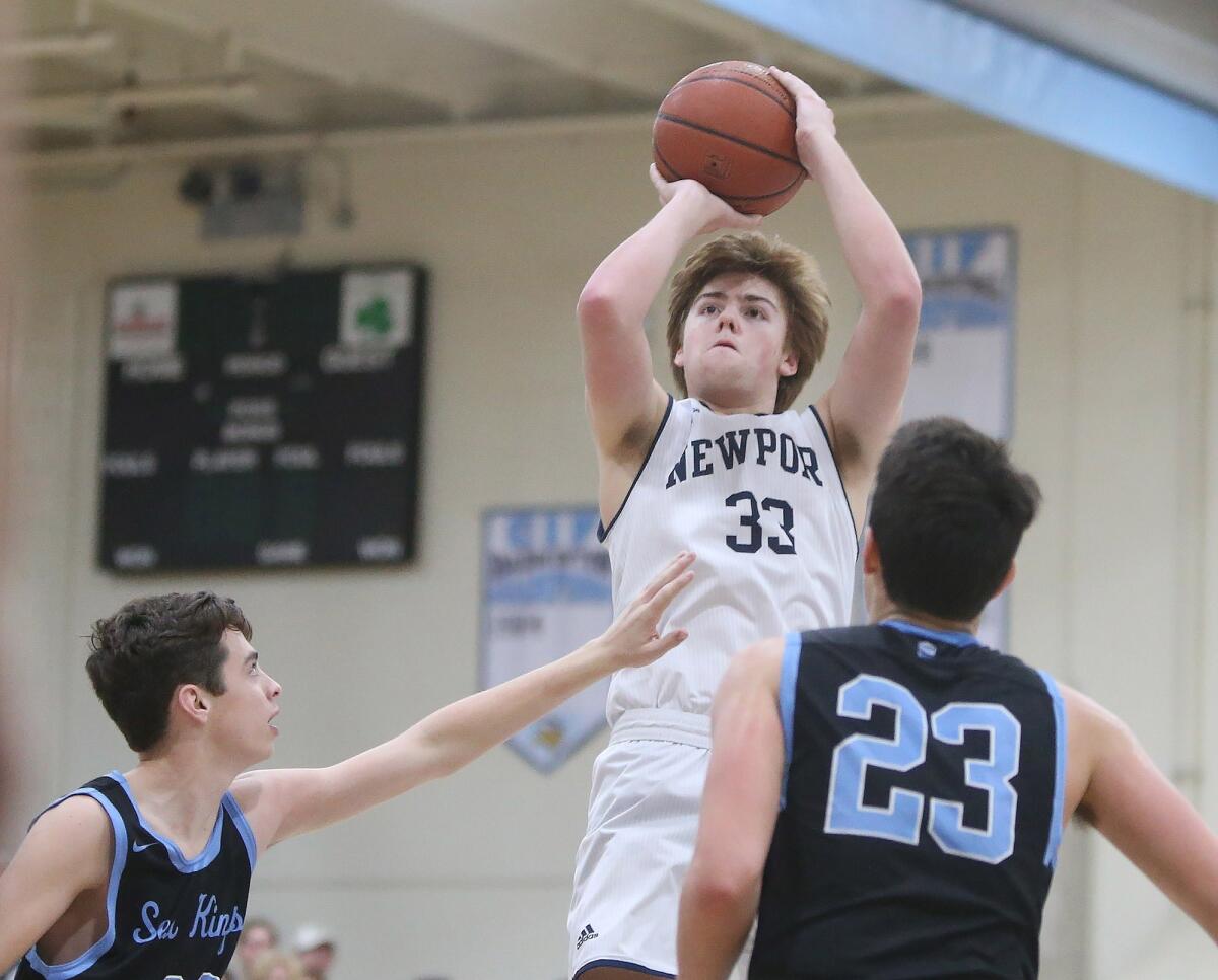 Newport Harbor High's Robbie Spooner, seen pulling up for a jumper against Corona del Mar on Jan. 31, scored 27 points in the Sailors' 70-61 loss at Temecula Valley on Tuesday.
