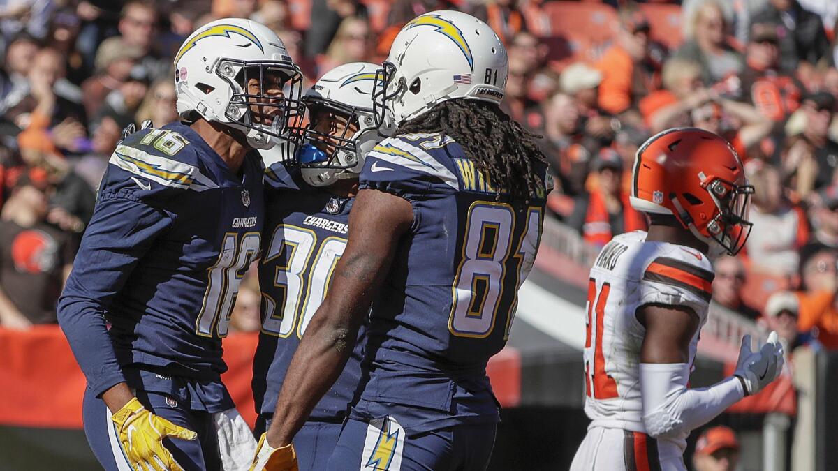Tyrell Williams celebrates with teammates Austin Ekeler and Mike Williams after catching a 29-yard touchdown pass from Chargers quarterback Philip Rivers.