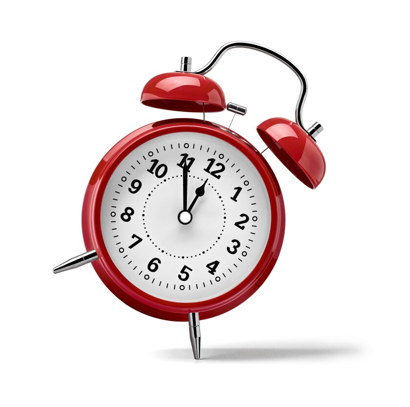 An alarm clock leaning on its side