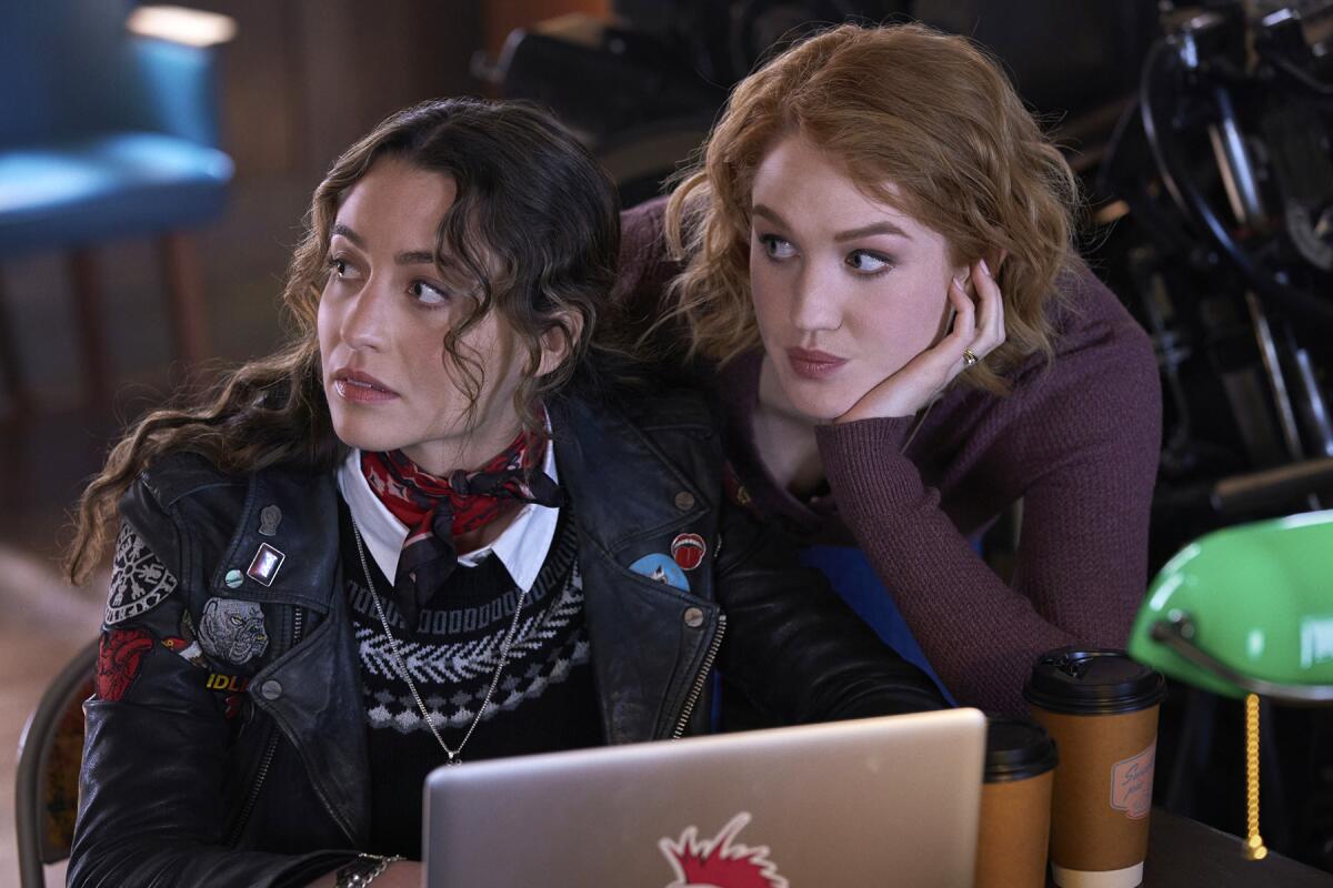 Stella Baker, left, and Hope Lauren look away from the screen of a laptop in "The Republic of Sarah" on the CW.