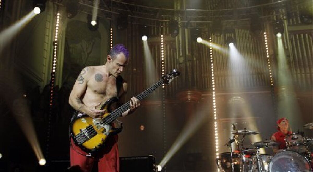A foot injury has led Red Hot Chili Peppers to postpone its 2012 winter tour, including its sold-out Feb. 28 San Diego show, which has been re-scheduled for September. The Los Angeles band is among the artists who will be inducted into the Rock and Roll Hall of Fame's Class of 2012 this year. (AP Photo/Peter Morrison)
