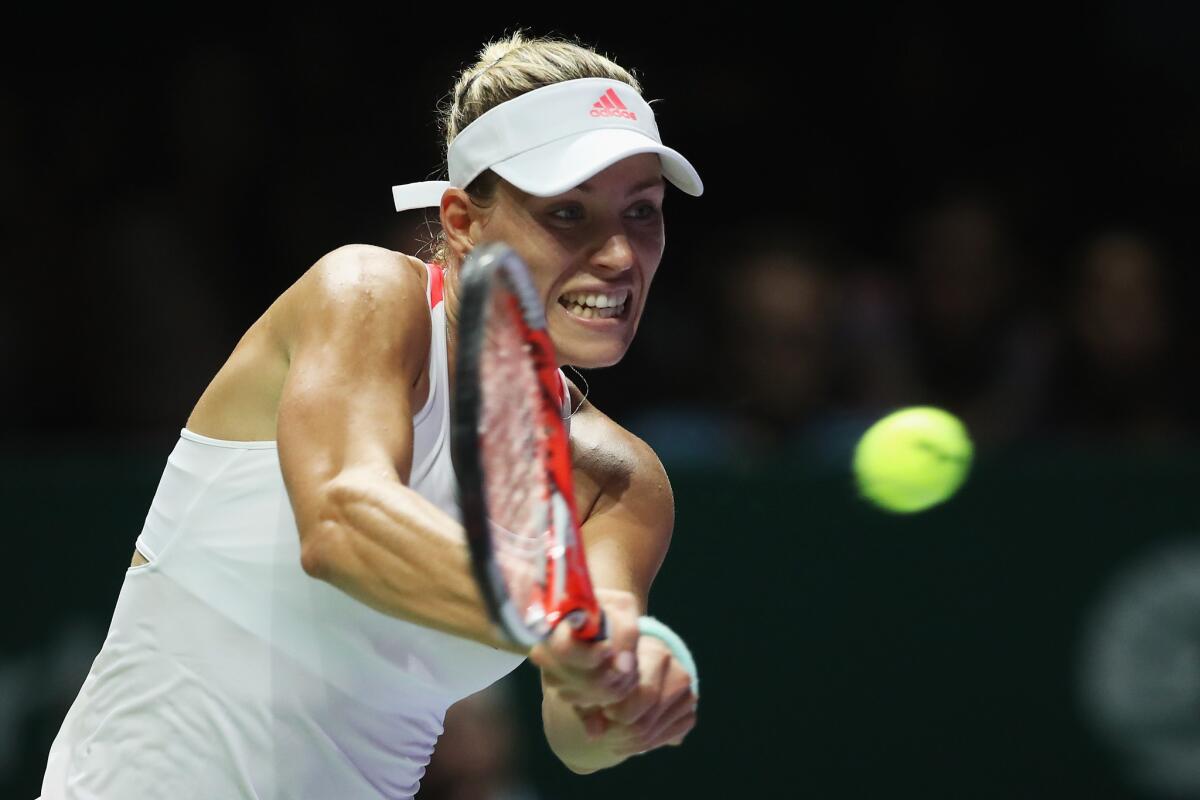 Angelique Kerber plays a backhand in her singles match against Simona Halep during day 3 of the BNP Paribas WTA Finals Singapore at Singapore Sports Hub on Oct. 25.