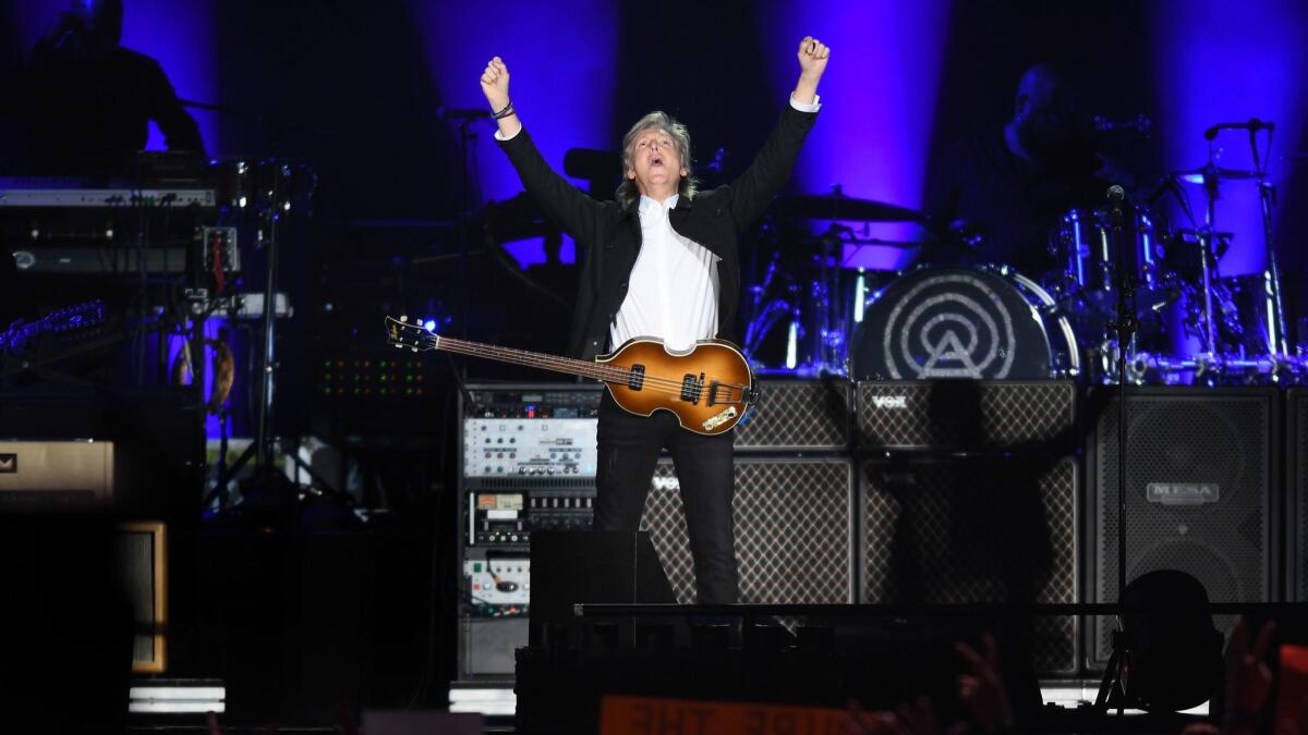 Paul McCartney performs to a sold-out crowd Saturday at Dodger Stadium, where he was joined near the end of the show by his former bandmate in the Beatles, drummer Ringo Starr.