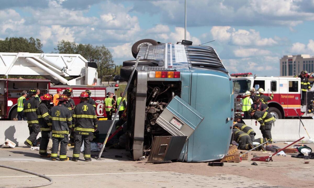 Firefighters work to extricate people trapped after a bus crash in Indianapolis. Three people were killed and 26 hospitalized. The bus was carrying teenagers home from a church camp in Michigan.